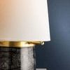 Petite table lamp with large white linen shade and dark Nero Madera marble base with aged brass spokes
