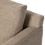 Close-up of back cushion and rear armrest edge showing upholstery weave and padding
