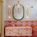 Catrine pendant hanging above a colorful bathroom sink with orange, pink, and green decor accents