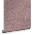 Rolled wallpaper showing texture and crosshatch pattern in mauve with curled bottom edge