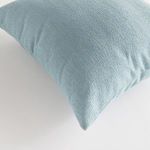 Close-up of Cooper Square pillow’s woven light blue Jacquard fabric texture
