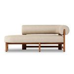Front view showing chaise’s thick cushioned seat and cylindrical backrest in beige fabric