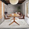 Rug showcased in the same dining room environment styled with a modern art piece on wooden wall