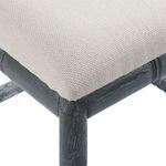 Close-up of beige linen fabric texture on the cushion and adjoining wood frame