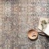 Close-up overhead on rug surface showing scattered decor with bowl and open book