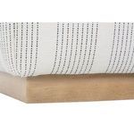 Close-up of wooden base with small natural imperfections beneath striped fabric upholstery