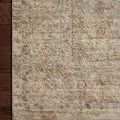 Corner section of rug on hardwood floor highlighting texture and soft muted color details