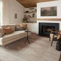 Rivers Lilac/Ivory Rug styled in cozy living room with neutral-toned sofa, black fireplace, and wood ceiling