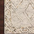 Segment of rug on dark wood floor showing detailed border and diamond pattern with wool texture