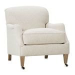Three-quarter shot from left side highlighting cushion thickness and armrest shape