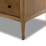 Close-up of bottom tapered leg with soft rounded foot and natural wood finish