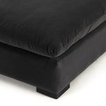 Close-up low angle shot of sofa base, cushion, and block feet with charcoal fabric