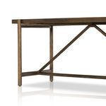 Close-up of metal diagonal brace and wood frame near base of console table
