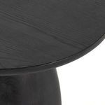Close-up showing round tabletop edge and wood texture in black wash ash finish