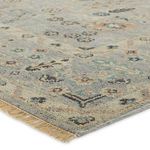 Close-up angle showing flat weave texture and fringed edge of Nysa blue-green rug
