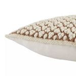 Side close-up showing boucle texture meeting smooth ivory linen fabric