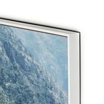 Close-up of white float mount edge with high-gloss finish on photo print of hillside and sea