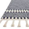 Close-up of Sawyer navy rug edge showing thick cream and navy fringes and patterned border
