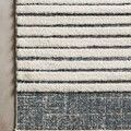 Textured polypropylene pile details and striped pattern of Hagen White Ocean Rug on smooth floor.