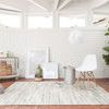 Ivory cowhide rug with hand-stitched leather panels in varying shades of cream and light beige, contemporary geometric design