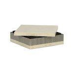 Square box with lid partially open showing black interior and vertical striped sides