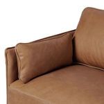 Detail of small rectangular side pillow resting against armrest