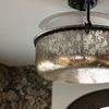 Side-angle view showing lantern’s textured mercury glass and part of an arched door
