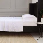 Queen bed dressed in white Sheena Bamboo Sateen Sheet Set with smooth bamboo fabric and neatly tucked corners