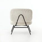 Detailed view of ivory angora upholstery texture on rounded edge of chair seat