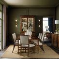 Dining room setting with multiple upholstered Archive chairs around dark wood table on light rug