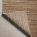 Curled corner of Merrick Oatmeal Multi rug revealing woven backing