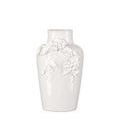 Another view of the small vase showing the hand-formed flower cluster and leaf details from a slight side angle