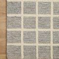 Corner close-up of Polly Slate Ivory Rug displaying the wool and jute hand-tufted texture