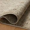 Rolled edge close-up illustrating flexible material and soft pile on hardwood floor