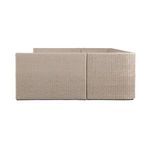 Back view displaying tightly woven rattan paneling and square corners of the outdoor banquette