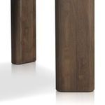 Close view of floor-touching section of wide cylindrical dining table leg