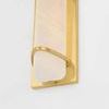 Close-up of the lower part of the sconce showing matte cloud glass and curved brass mounting detail