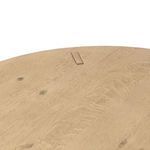Top-down view highlighting natural wood knots and joinery on round table