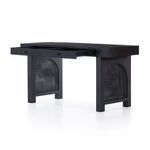 Close-up depicting cane panel pattern inside arched leg frame of the Tilda black wash desk