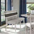 Peyton Banquette positioned in a dining area with blue curtains, light wood table and chairs on a gray rug.