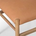 Detailed close-up showing smooth camel leather texture and finished rounded ash leg