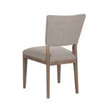 Rear angle of Phillip Dining Chair showing curved backrest upholstery and wooden frame support structure