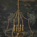 Nimes Chandelier lit in front of dark scenic wall mural, showcasing profile view