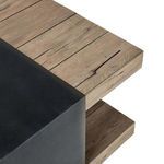 Close-up of table top corner showing weathered oak wood grain and smooth matte black iron centerpiece edge