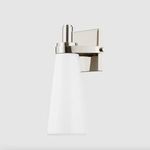 Close-up of the Trude Wall Sconce metal mounting plate with polished finish and tapered shade