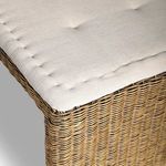 Tight rattan weave pattern in natural tones on bench surface