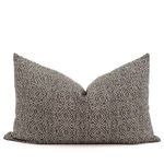 Rectangular lumbar pillow with same tan patterned fabric and brown gray background