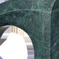 Close-up of green marble texture showing natural veining and polished surface on curved edge