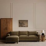 Tade tall cabinet next to large olive green sectional sofa in elegant living room