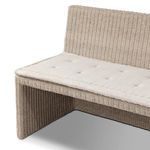 Close-up angle showing rattan frame supporting tufted fabric cushion on outdoor dining banquette